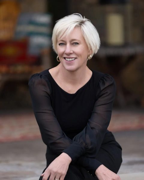 Jen, our local property manager in Bozeman, smiling in a black top